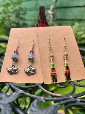 Coca-Cola and Cat earrings.